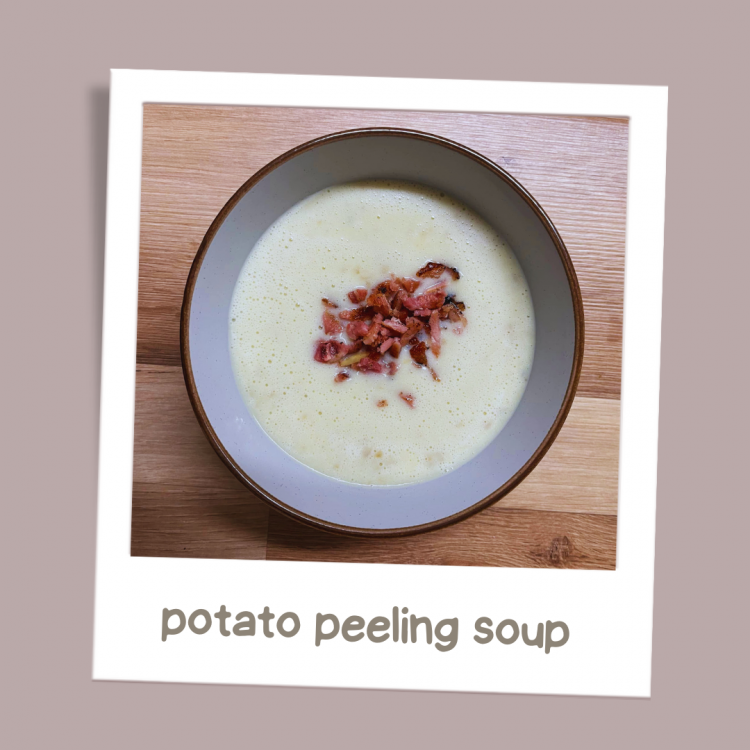 Photo of potato peeling soup with crispy bacon bits garnish